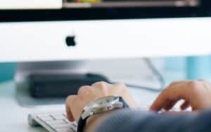 a person typing on a keyboard